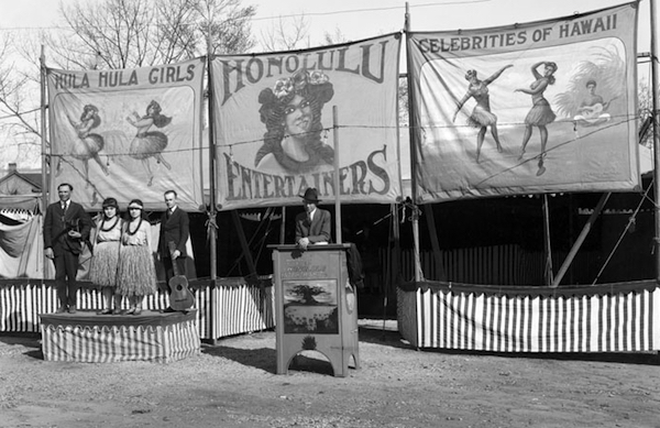 A sideshow tent at a 1920 circus in Salt Lake City boasts, "Hula Hula Girls, " "Honolulu Entertainers," and "Celebrities of Hawaii." (By Harry Shipler, via WikiCommons)