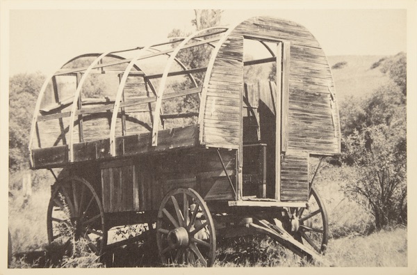This tourist postcard labeled "Montana Sheepwagon, Sheepherder's Mobile Home" shows an early wagon with a house-sized door. (From Don't Call Them Trailer Trash, courtesy of Schiffer Publishing)