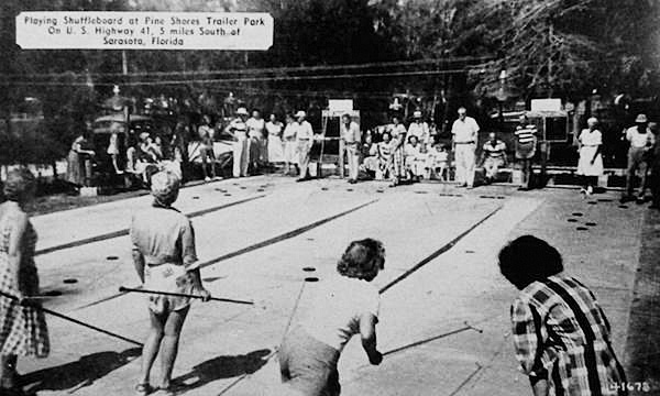 The manager of Pine Shores Trailer Park in Sarasota, Florida, sent this shuffleboard postcard to entice a Maine citizen to winter there in 1949. He promised a new large bathhouse, modern laundry, improved electrical and water systems, an attractive recreation hall, and fishing. (Via eBay)