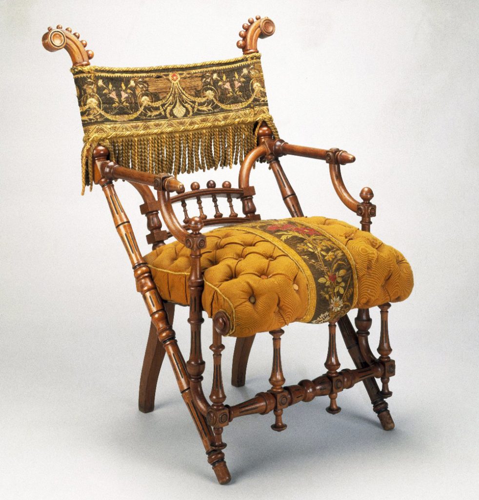 This armchair's original overstuffed cushion and fringed back panel overpower the whimsical geometric shapes of its turned wood members, circa 1869. Via the Brooklyn Museum.