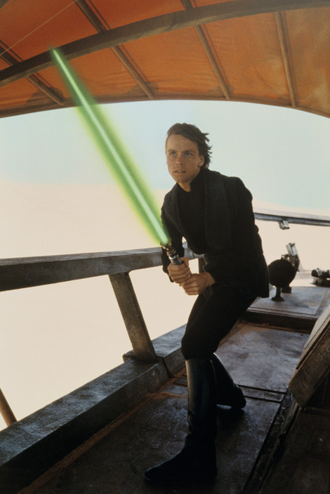 Luke Skywalker holds Obi-Wan's lightsaber on the barge based on Commodore Tompkins' model in a still from "Return of the Jedi."