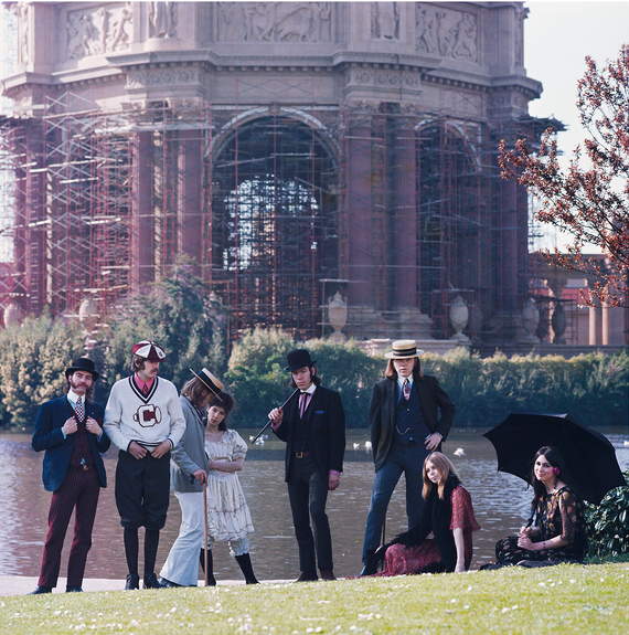 The Charlatans and some of their "old ladies," photographed at the Palace of Fine Arts in San Francisco by Herb Greene. From left to right: Mike Ferguson, Dan Hicks, George Hunter, Lucy Lewis, Mike Wilhelm, Richard Olsen, Susan Pilborough, and Carmella "Candy" Storniola.